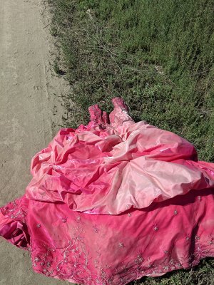 Those cleaning up the illegal dump site near Stratford found some unusual items, including this Quinceanera dress used for the celebration of a girl's 15th birthday.